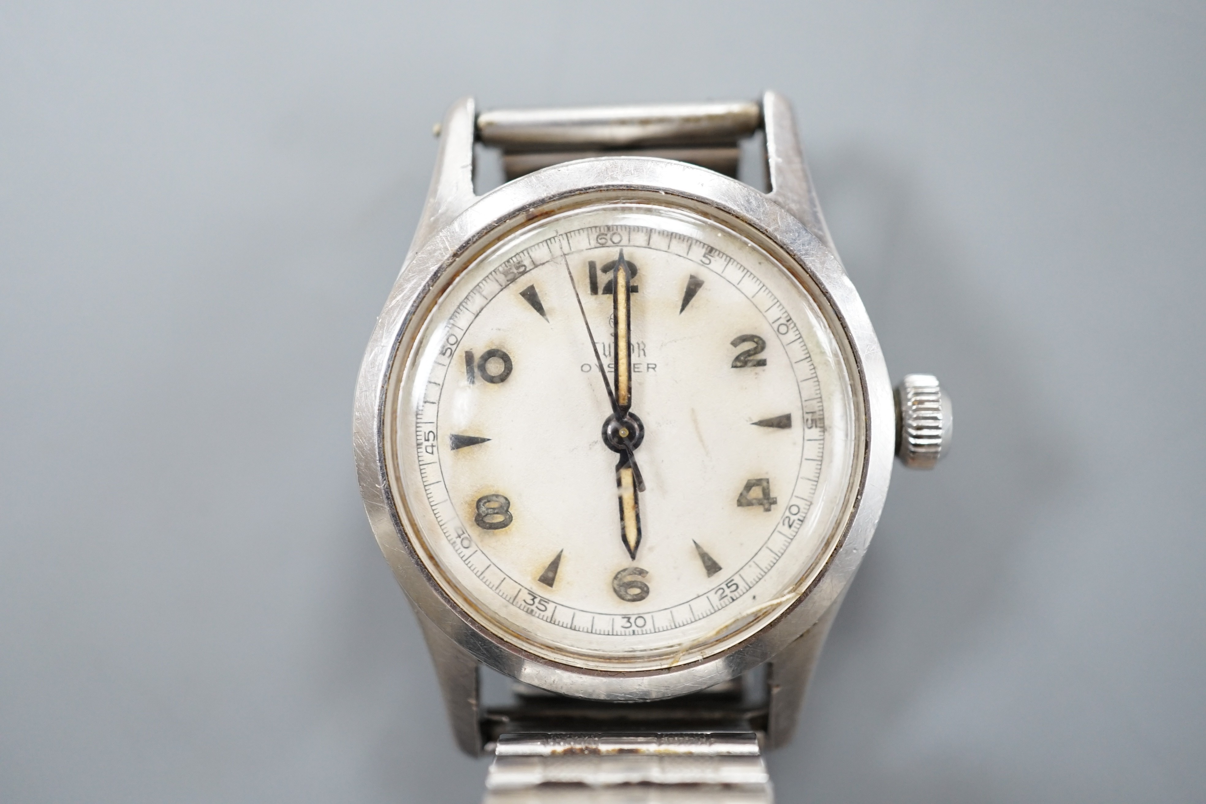 A gentleman's stainless steel Tudor Oyster manual wind wrist watch, with baton and Arabic numerals, on associated flexible bracelet, case diameter 32mm, case back numbered 449386.